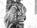 Inuit woman wearing decorated parka, with a child in the amuat. 1925-26